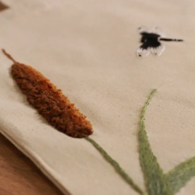 Green botanical sprig embroidery